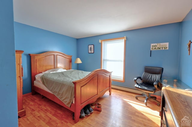 bedroom featuring a baseboard radiator and light wood finished floors