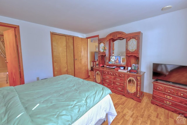 bedroom with a closet and wood finished floors