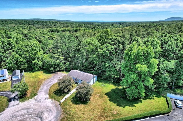 drone / aerial view featuring a forest view