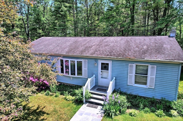 ranch-style house with a shingled roof