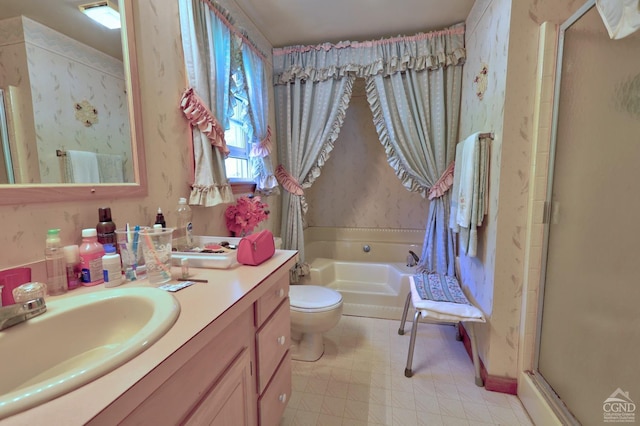 bathroom featuring toilet, a stall shower, a bath, and vanity