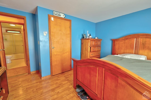 bedroom featuring light wood-style floors and baseboards