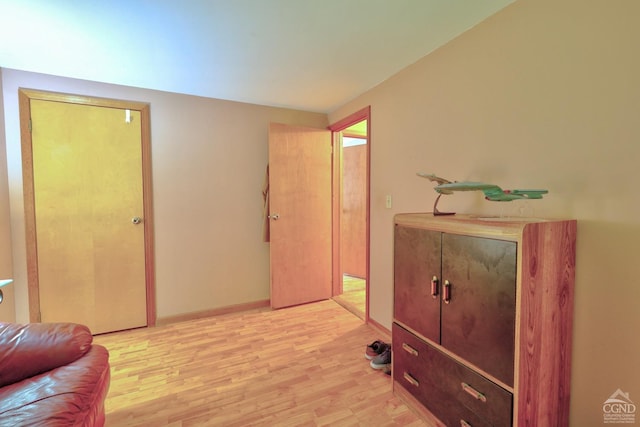 living area with light wood-style flooring and baseboards