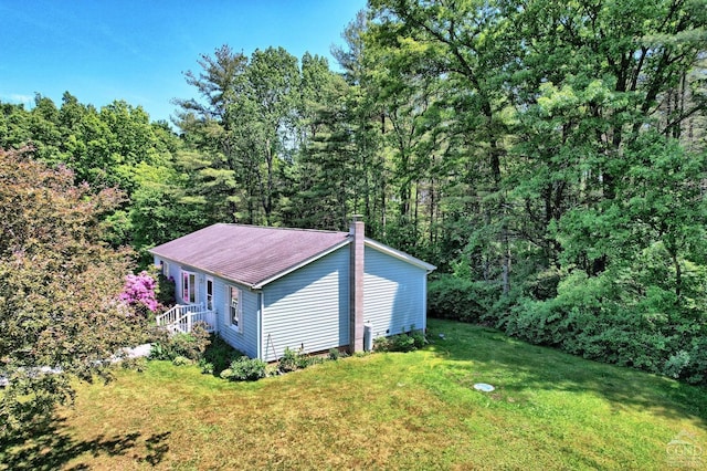 view of outbuilding with a view of trees