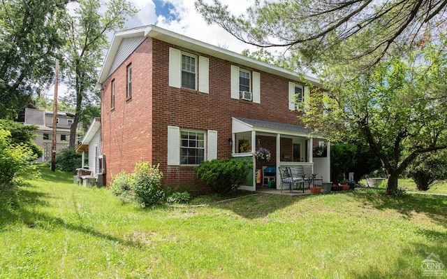 rear view of property with a yard and a patio