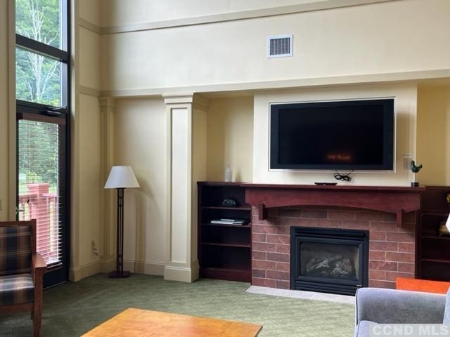 carpeted living room with a fireplace