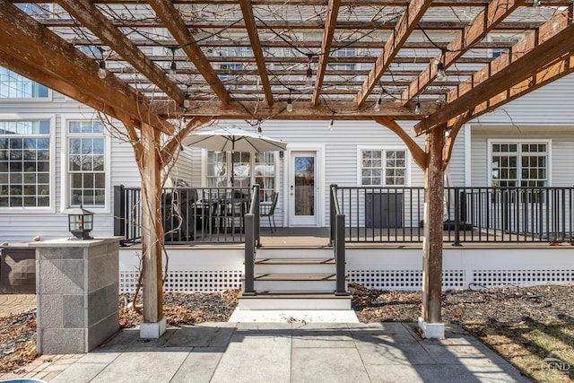 entrance to property featuring a deck and a pergola