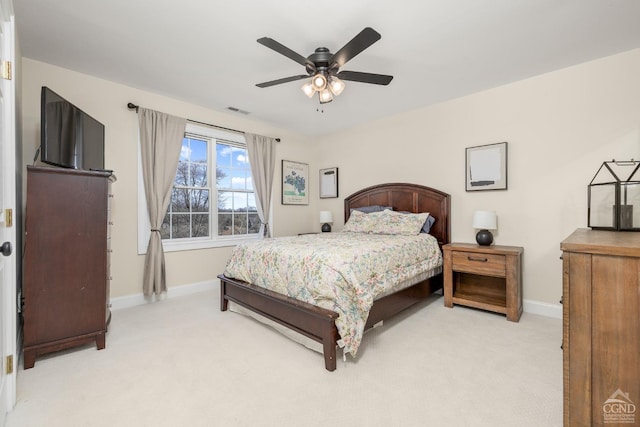 bedroom with ceiling fan, baseboards, visible vents, and light carpet