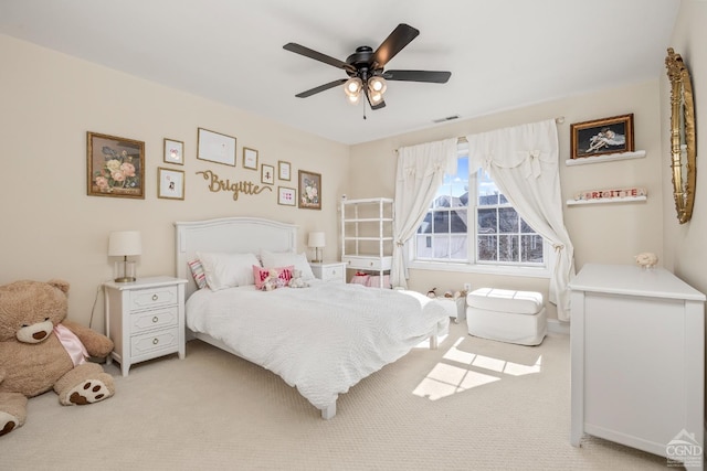bedroom featuring ceiling fan, visible vents, and light carpet