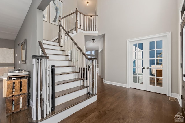 foyer entrance with stairway, wood finished floors, visible vents, baseboards, and french doors