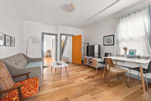 living area with stairs and light wood-type flooring