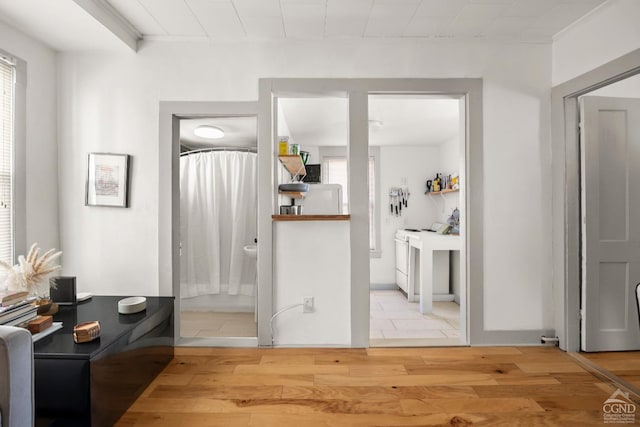 interior space with a shower with shower curtain and wood finished floors