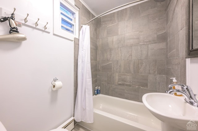 full bathroom featuring shower / bath combo with shower curtain, a baseboard heating unit, and a sink