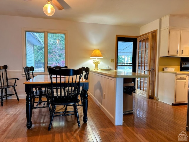 dining space with light wood-type flooring and ceiling fan