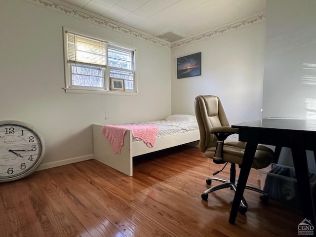 bedroom with hardwood / wood-style flooring