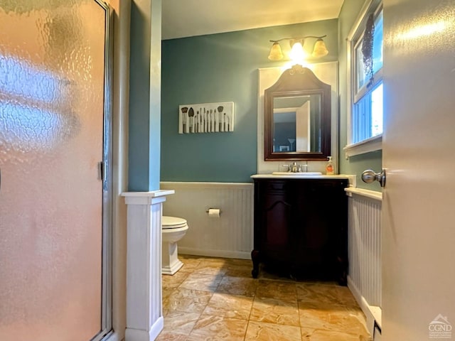 bathroom with toilet, wood walls, an enclosed shower, and vanity