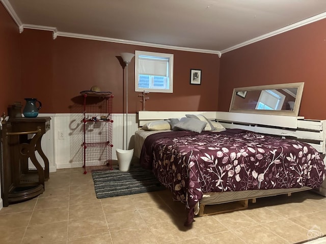 bedroom with light tile patterned flooring and ornamental molding