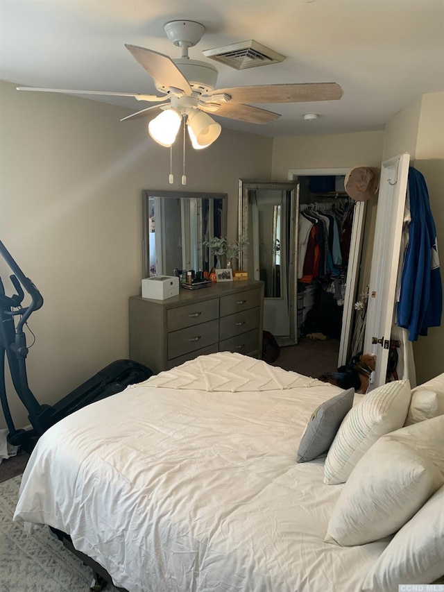 bedroom featuring dark colored carpet, ceiling fan, and a closet