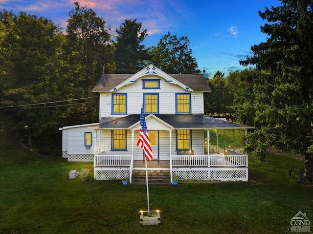 farmhouse with covered porch and a yard