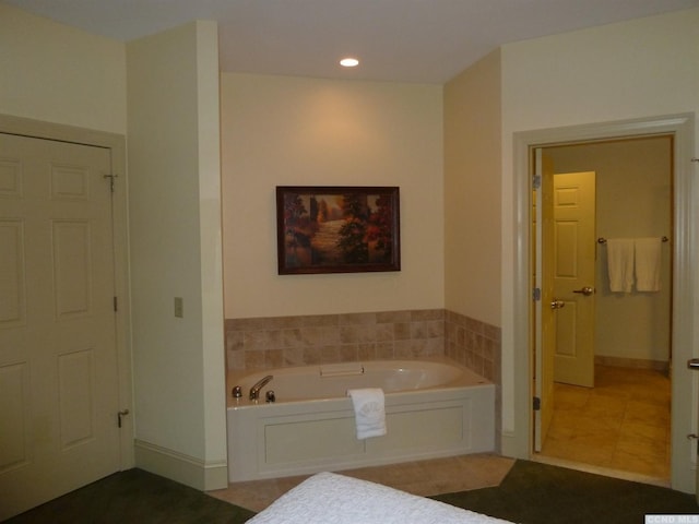 bathroom featuring tile patterned flooring and a bathtub