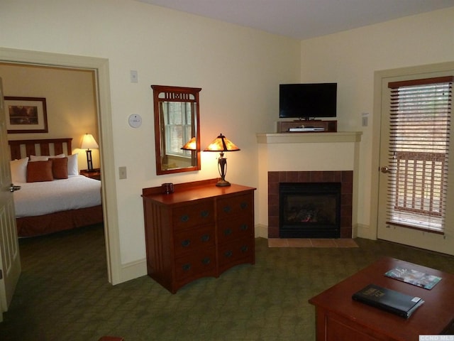 carpeted living room featuring a tile fireplace