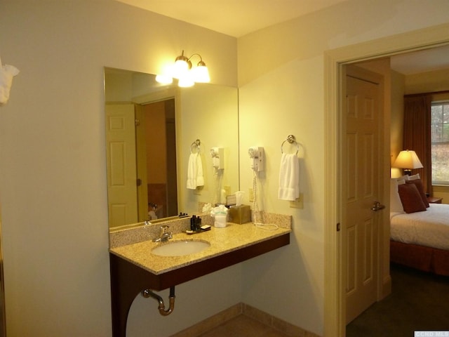 bathroom featuring sink and a chandelier