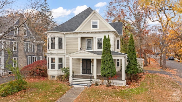 victorian-style house featuring a front yard