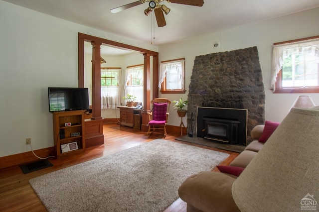 living room with ornate columns, ceiling fan, and hardwood / wood-style flooring