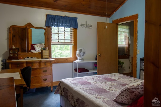 carpeted bedroom featuring lofted ceiling and wooden ceiling