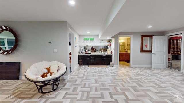 interior space with light parquet flooring and bar area