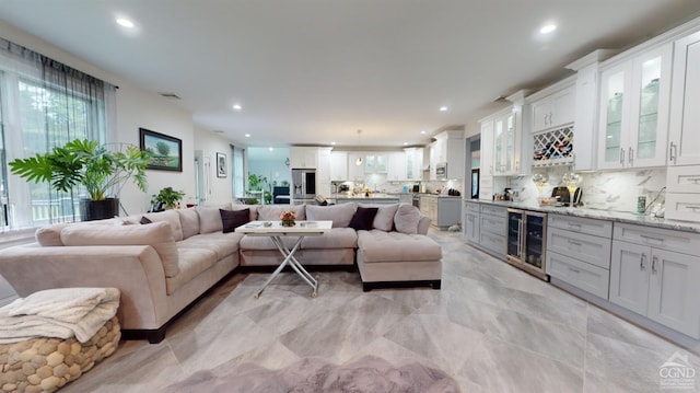 living room with beverage cooler and bar area