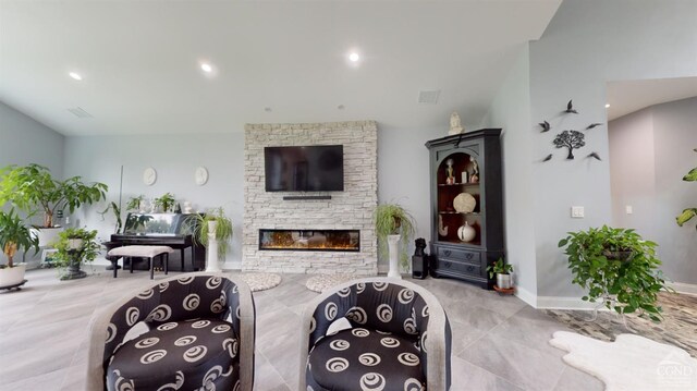 living room featuring a stone fireplace