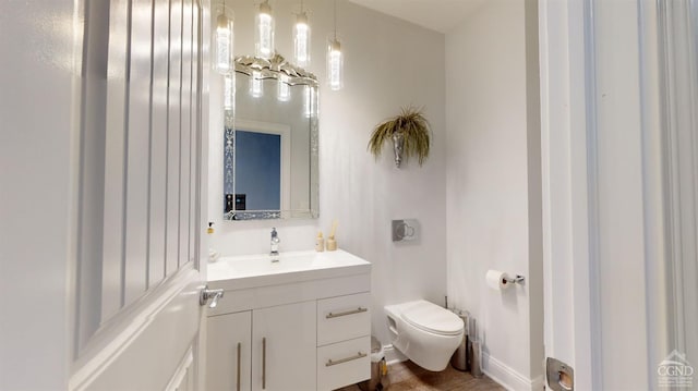 bathroom featuring hardwood / wood-style flooring, vanity, and toilet