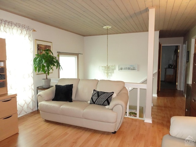 living room featuring light wood-type flooring, wooden ceiling, and a notable chandelier