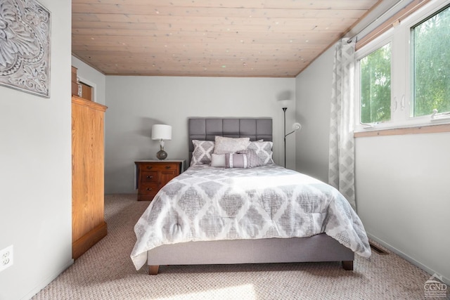 bedroom with carpet floors and wooden ceiling