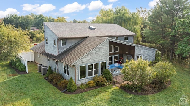 rear view of house featuring a patio area and a lawn