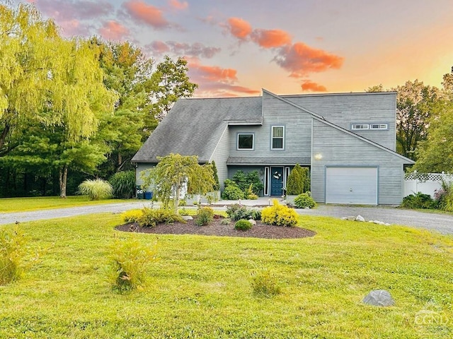 view of front of property with a yard and a garage