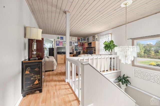 corridor featuring hardwood / wood-style flooring, a notable chandelier, and wooden ceiling