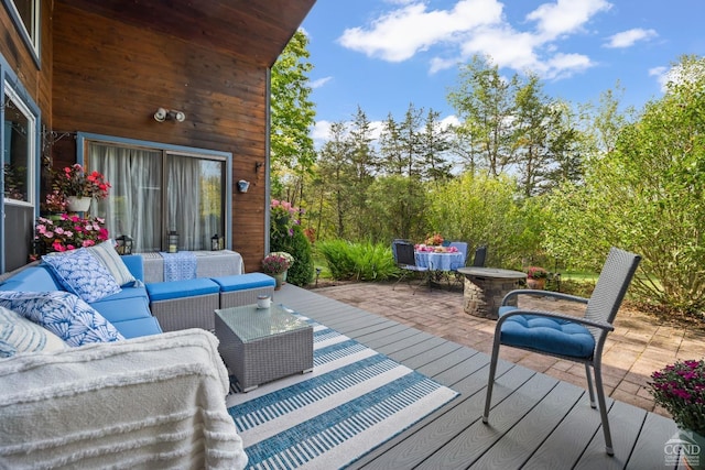 deck with an outdoor living space and a patio