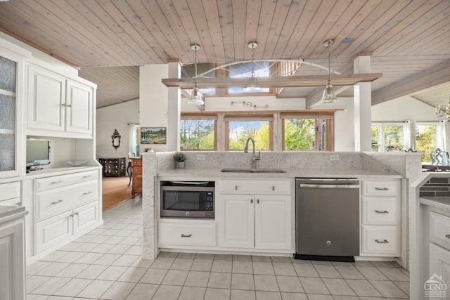 kitchen with sink, white cabinets, lofted ceiling, and appliances with stainless steel finishes