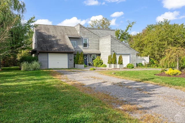 view of front facade with a front yard and a garage