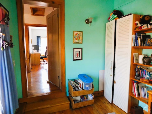 hallway with hardwood / wood-style floors