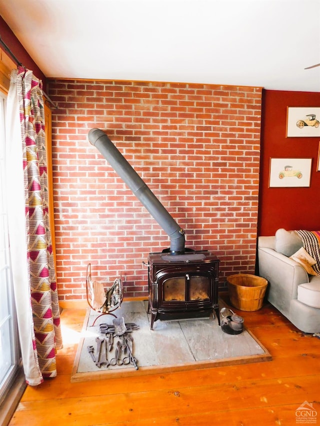 room details featuring hardwood / wood-style flooring and a wood stove