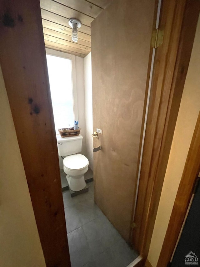 bathroom with toilet and wood ceiling