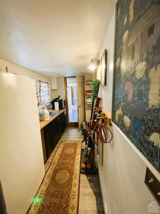 hall featuring sink and light hardwood / wood-style flooring