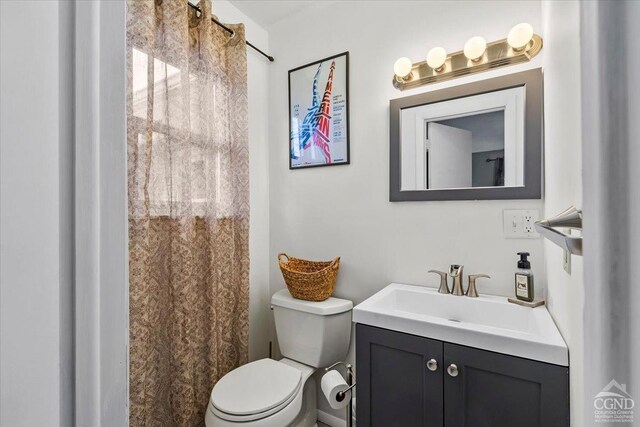 bedroom featuring ensuite bathroom and dark hardwood / wood-style floors