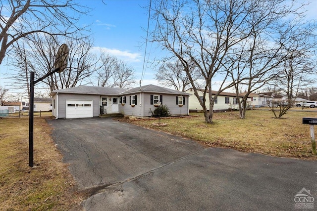 ranch-style home with a garage and a front lawn