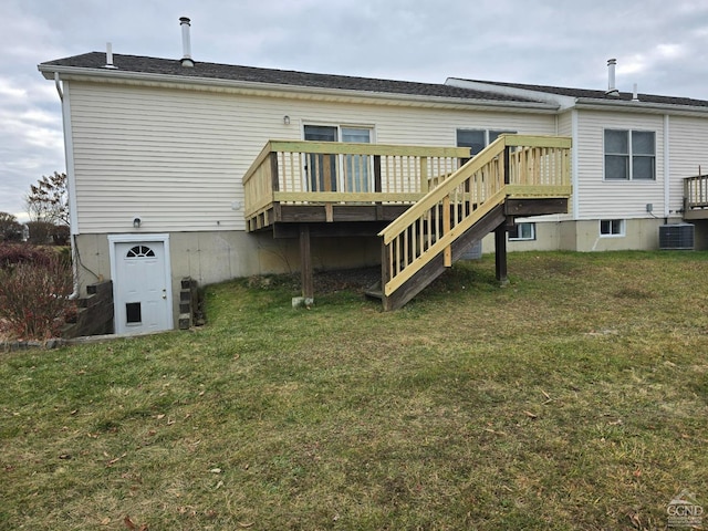 rear view of property featuring a lawn, a deck, central AC unit, and stairs