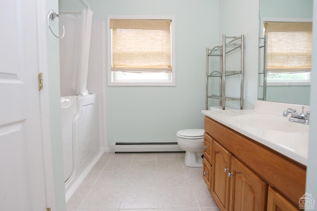 bathroom featuring plenty of natural light, baseboard heating, tile patterned flooring, and vanity