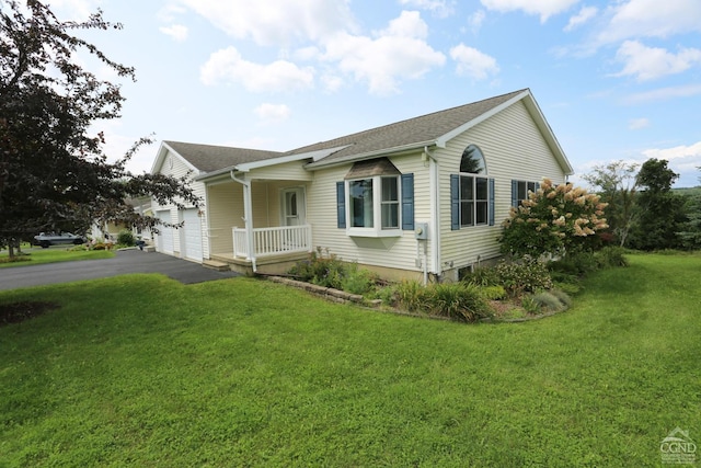 view of front of house featuring a garage, a front yard, roof with shingles, and driveway